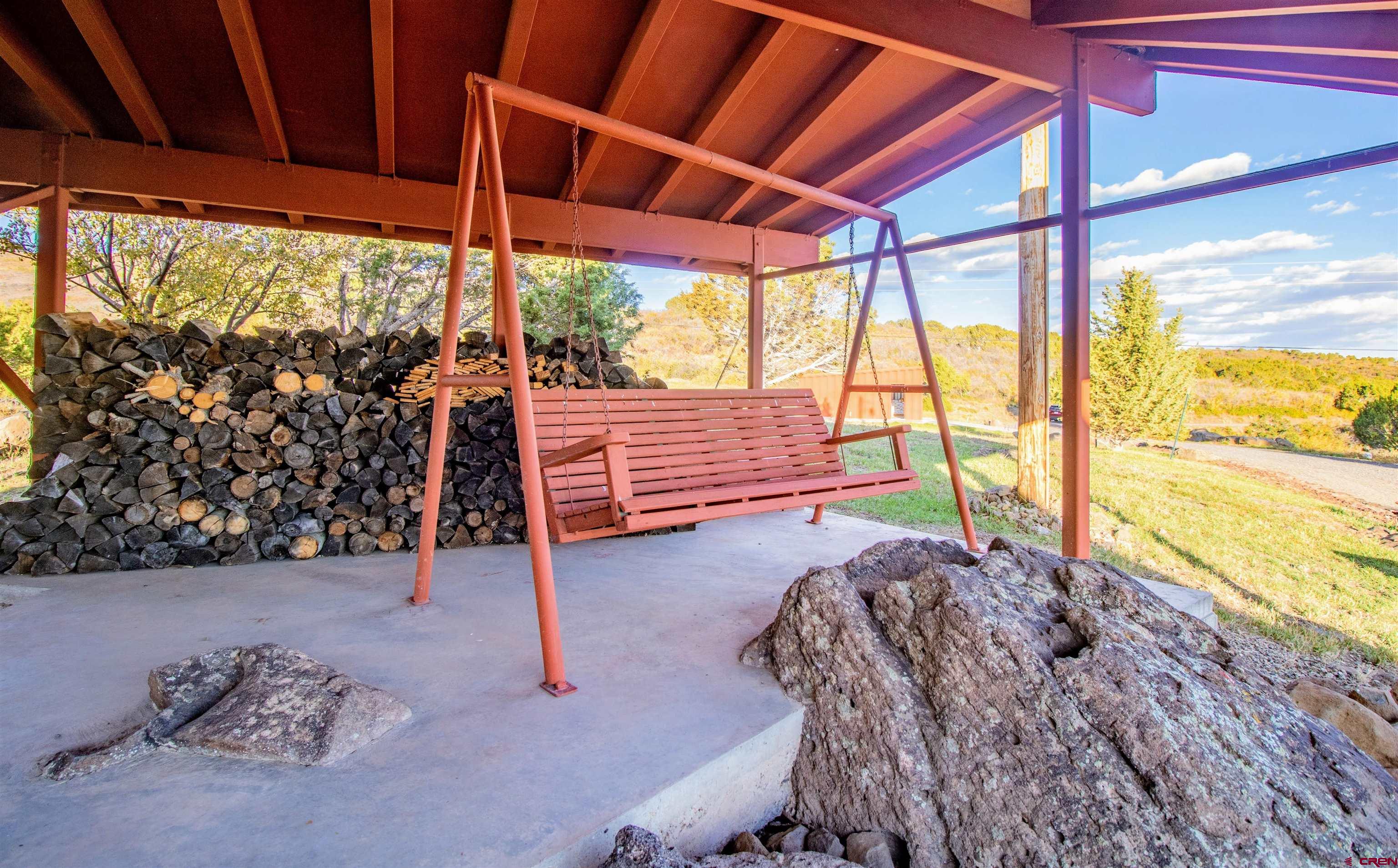 22211 Highway 65 Cedaredge, CO 81413 - Photo 12 of 35 a view of a porch with furniture and a yard