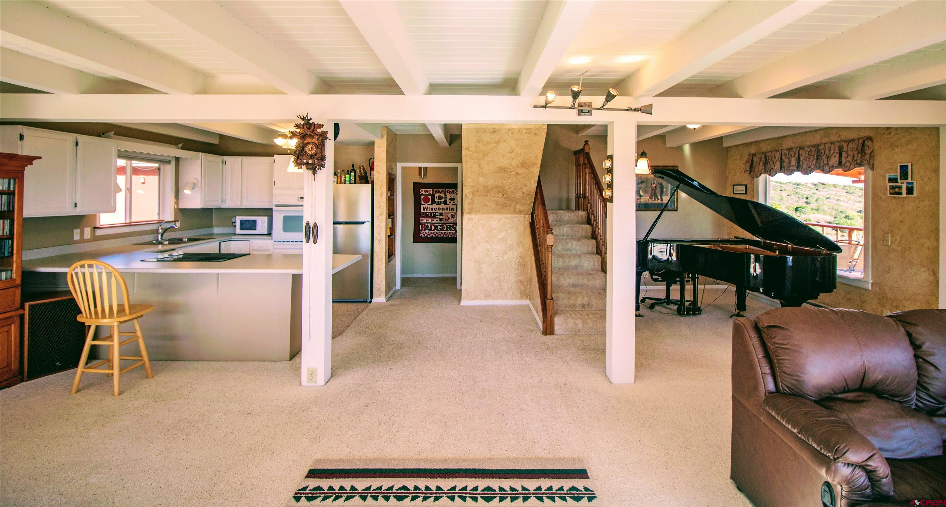22211 Highway 65 Cedaredge, CO 81413 - Photo 17 of 35 a kitchen with stainless steel appliances kitchen island granite countertop a table chairs in it and wooden floors