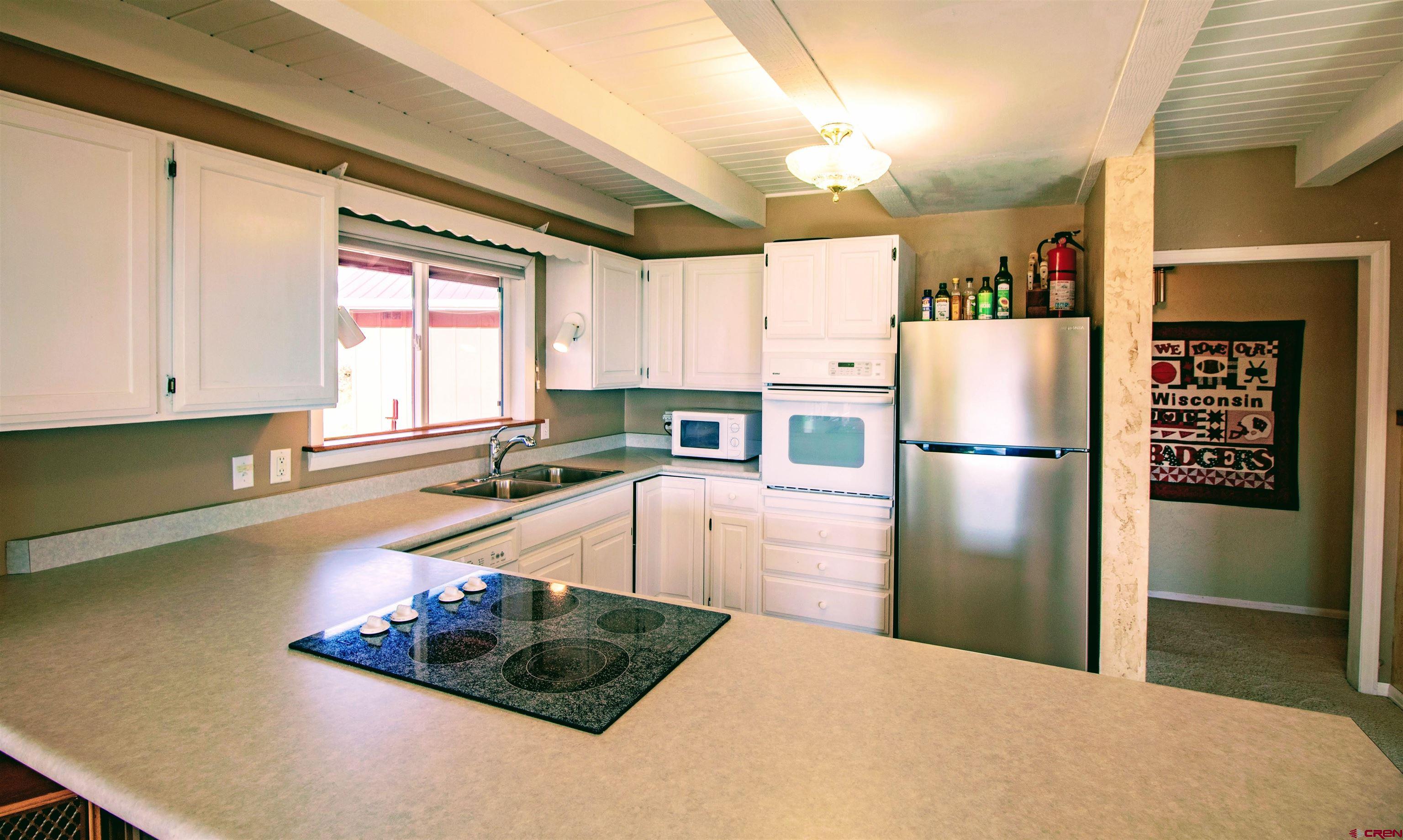 22211 Highway 65 Cedaredge, CO 81413 - Photo 19 of 35 a kitchen with refrigerator and window