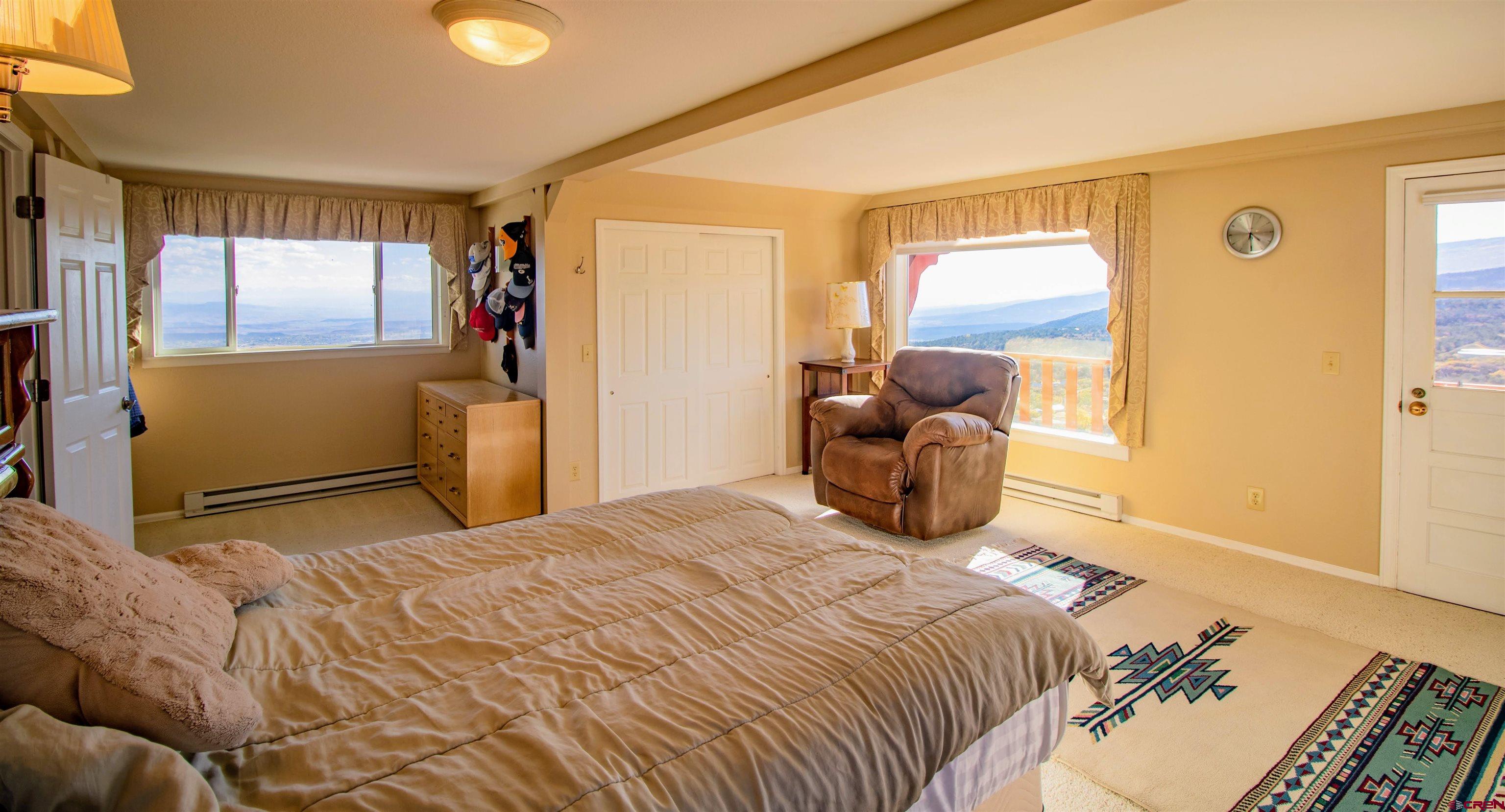 22211 Highway 65 Cedaredge, CO 81413 - Photo 23 of 35 a bedroom with a bed and wooden floor