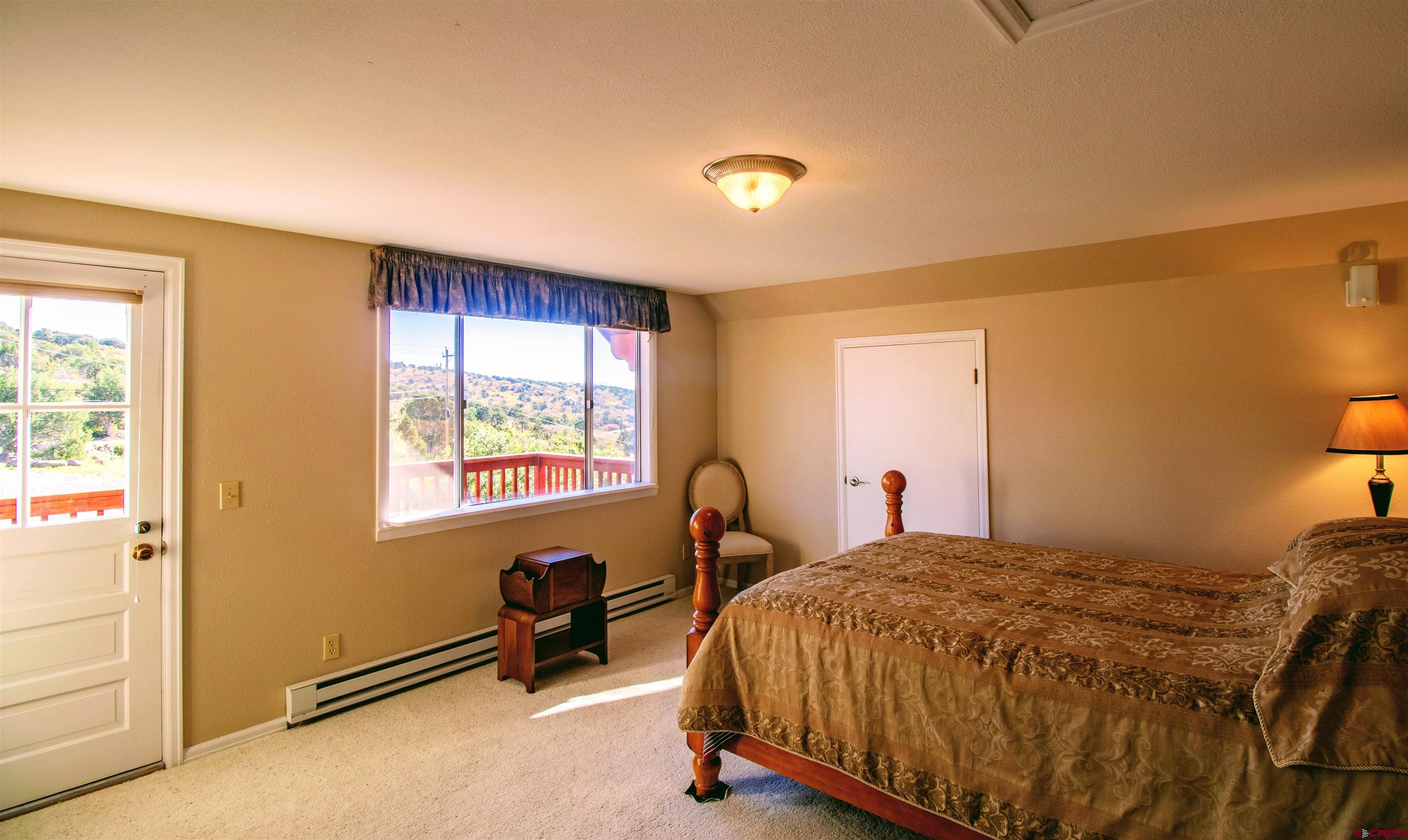 22211 Highway 65 Cedaredge, CO 81413 - Photo 24 of 35 a bedroom with a bed and a window