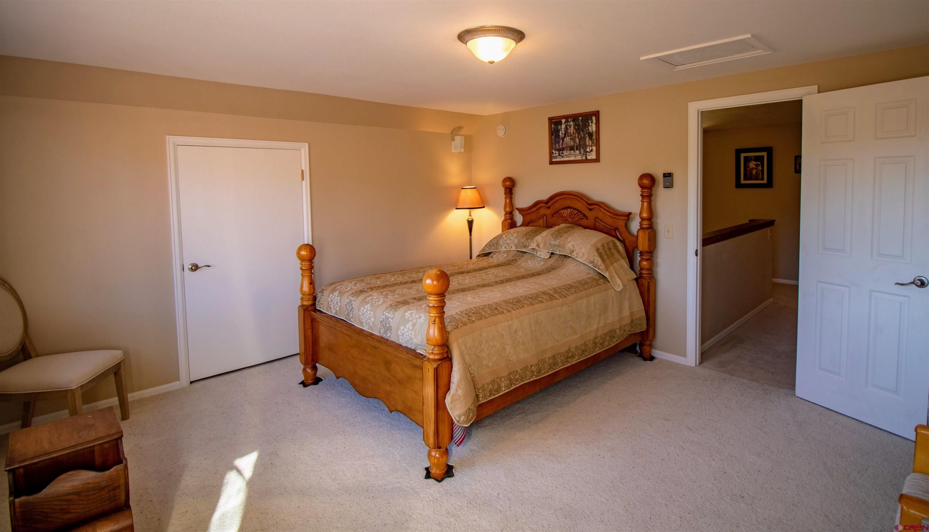 22211 Highway 65 Cedaredge, CO 81413 - Photo 25 of 35 a bedroom with a bed and a lamp