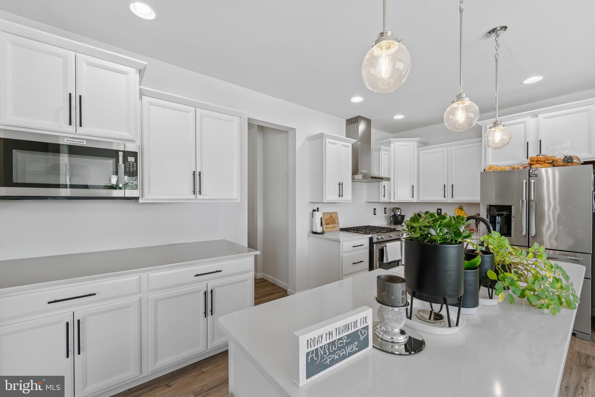 79 Beck Road York, PA 17403 - Photo 8 of 38 a kitchen with a white cabinets and chandelier