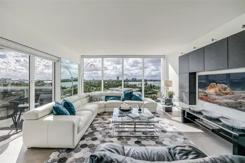 a living room with furniture large window and a flat screen tv