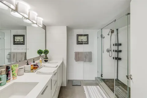 a bathroom with a sink a vanity and shower