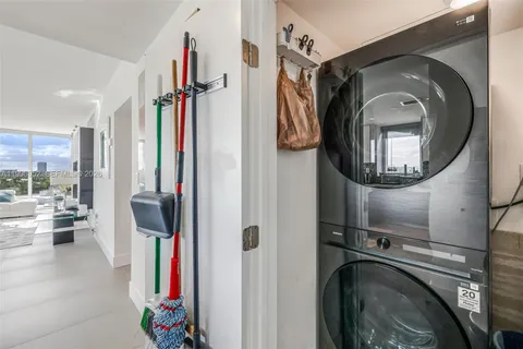a view of a bathroom with entryway wooden floor and a chandelier