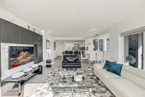 a living room with furniture a couch and a flat screen tv