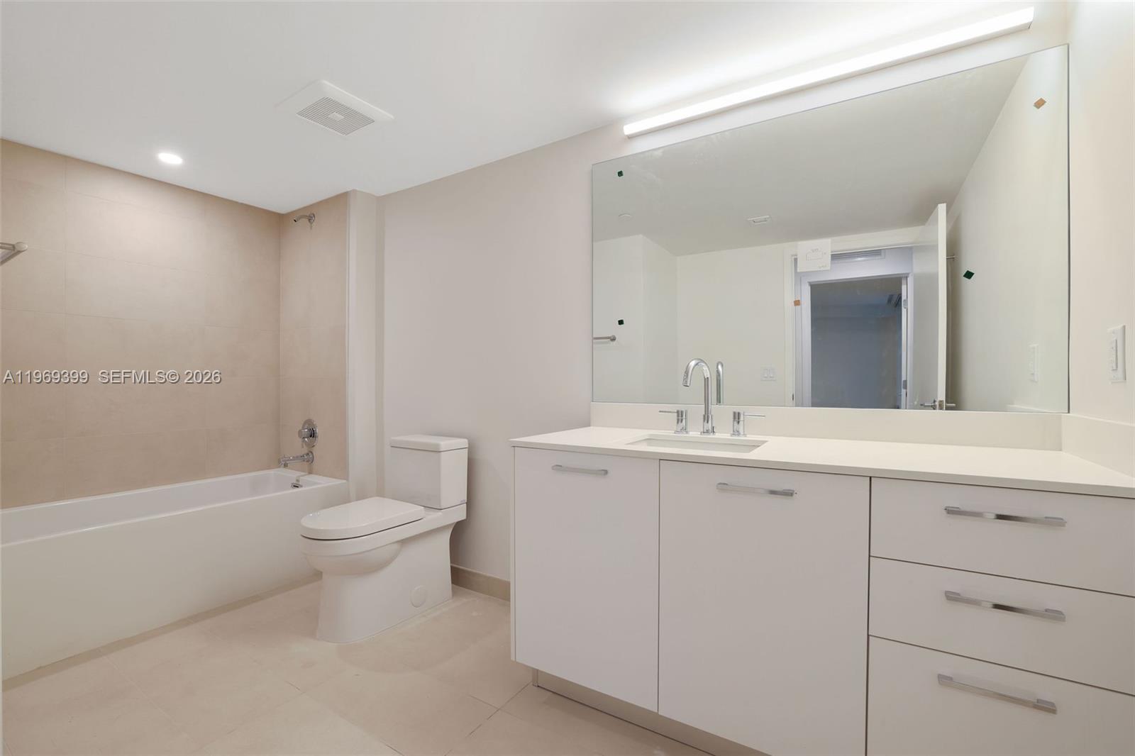 1504 Bay Road, Unit N1208 Miami Beach, FL 33139 - Photo 17 of 84 a bathroom with a toilet a sink a mirror and a bathtub