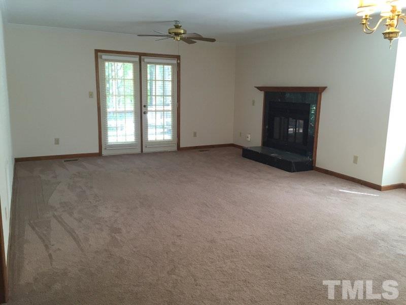 6239 Fountainhead Drive Raleigh, NC 27609 - Photo 2 of 17 a view of an empty room with a fireplace and a window