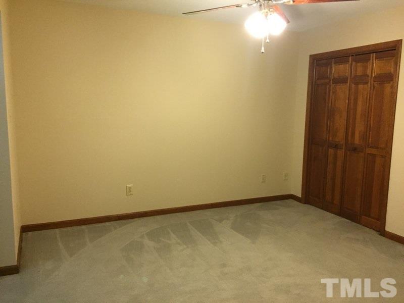 6239 Fountainhead Drive Raleigh, NC 27609 - Photo 12 of 17 an empty room with a door