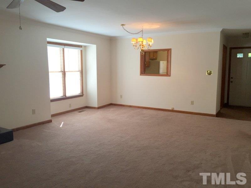 6239 Fountainhead Drive Raleigh, NC 27609 - Photo 4 of 17 an empty room with windows and closet