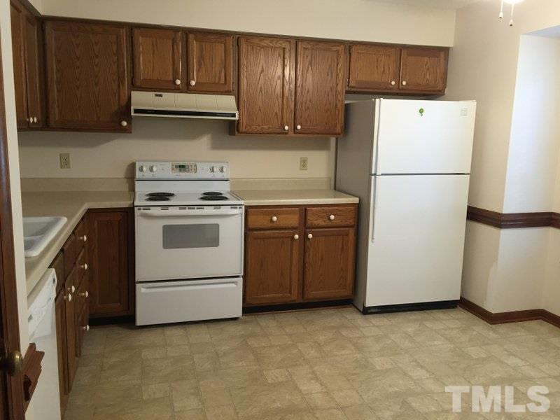 6239 Fountainhead Drive Raleigh, NC 27609 - Photo 6 of 17 a kitchen with a stove sink and refrigerator
