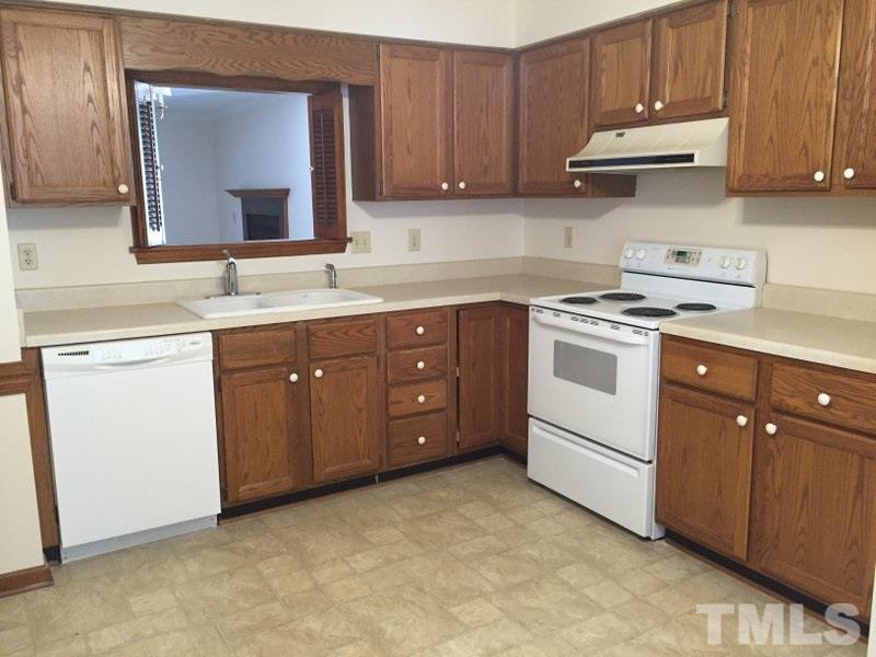 6239 Fountainhead Drive Raleigh, NC 27609 - Photo 7 of 17 a kitchen with a sink stove and cabinets