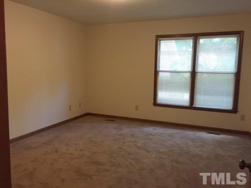 6239 Fountainhead Drive Raleigh, NC 27609 - Photo 8 of 17 an empty room with a window