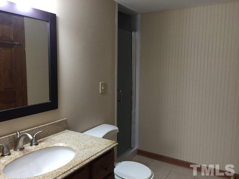 6239 Fountainhead Drive Raleigh, NC 27609 - Photo 9 of 17 a bathroom with a granite countertop sink toilet and mirror