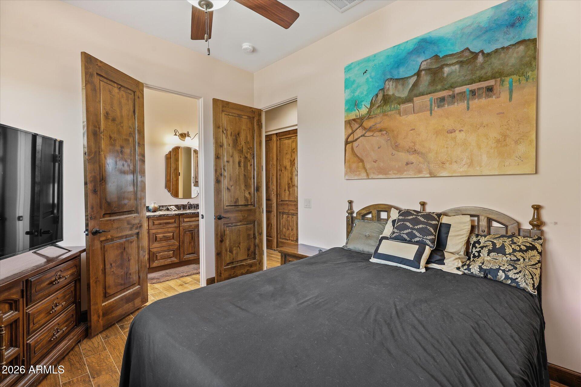 53 North La Barge Road Apache Junction, AZ 85119 - Photo 26 of 40 a bedroom with a bed and a flat screen tv