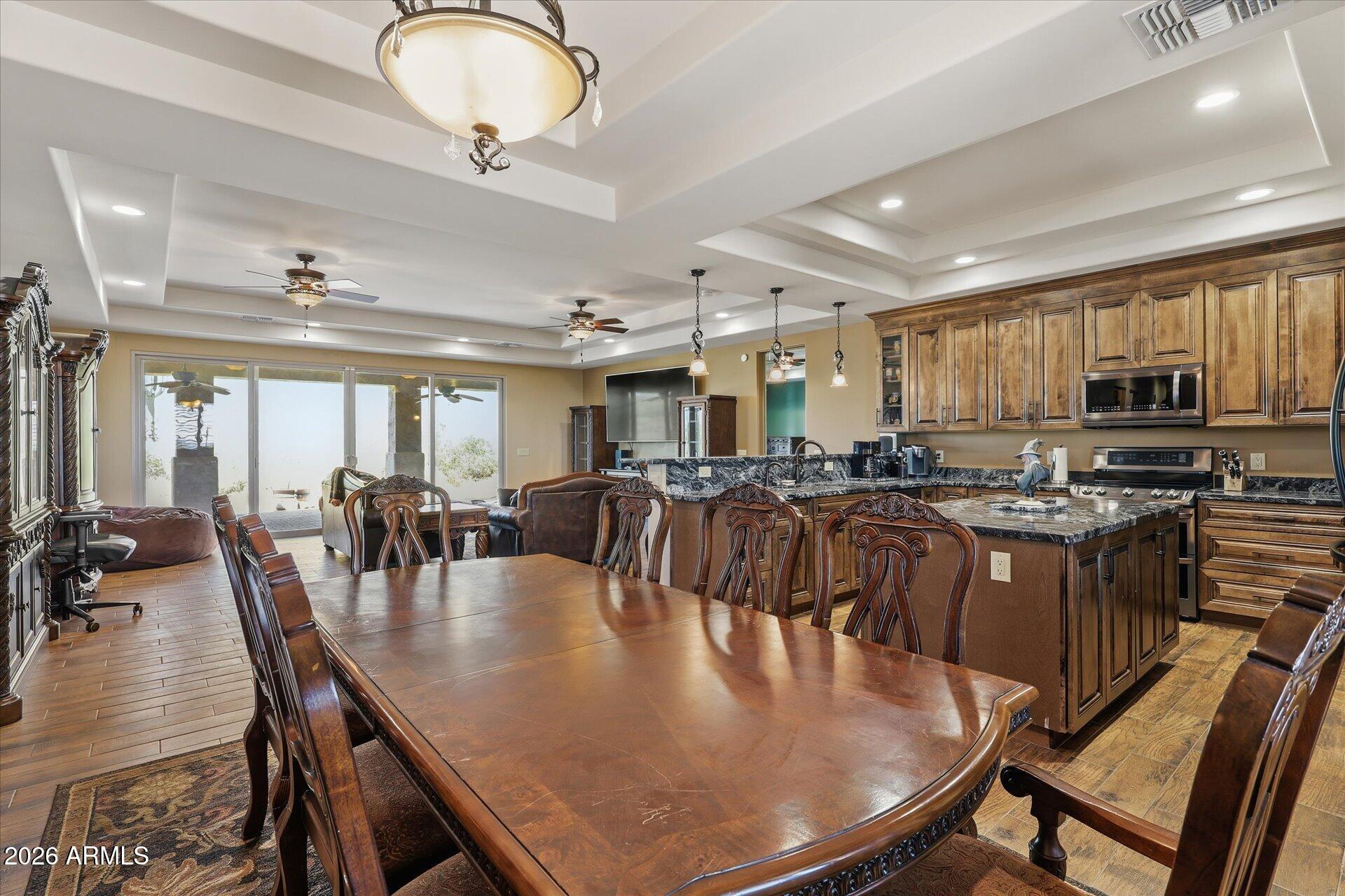 53 North La Barge Road Apache Junction, AZ 85119 - Photo 27 of 40 a dining room with stainless steel appliances kitchen island granite countertop a dining table chairs and granite counter tops