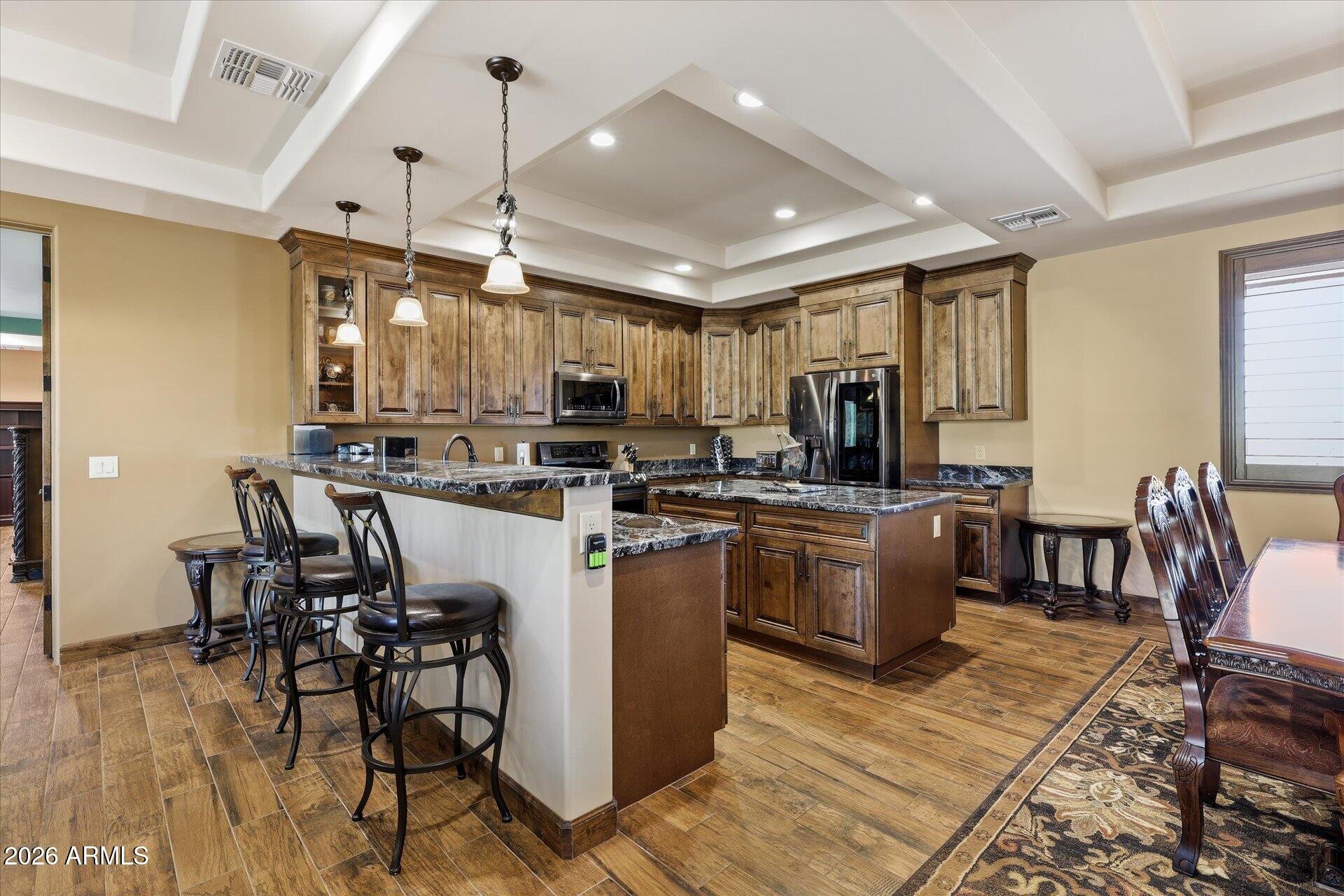 53 North La Barge Road Apache Junction, AZ 85119 - Photo 29 of 40 a kitchen with a table chairs microwave and cabinets