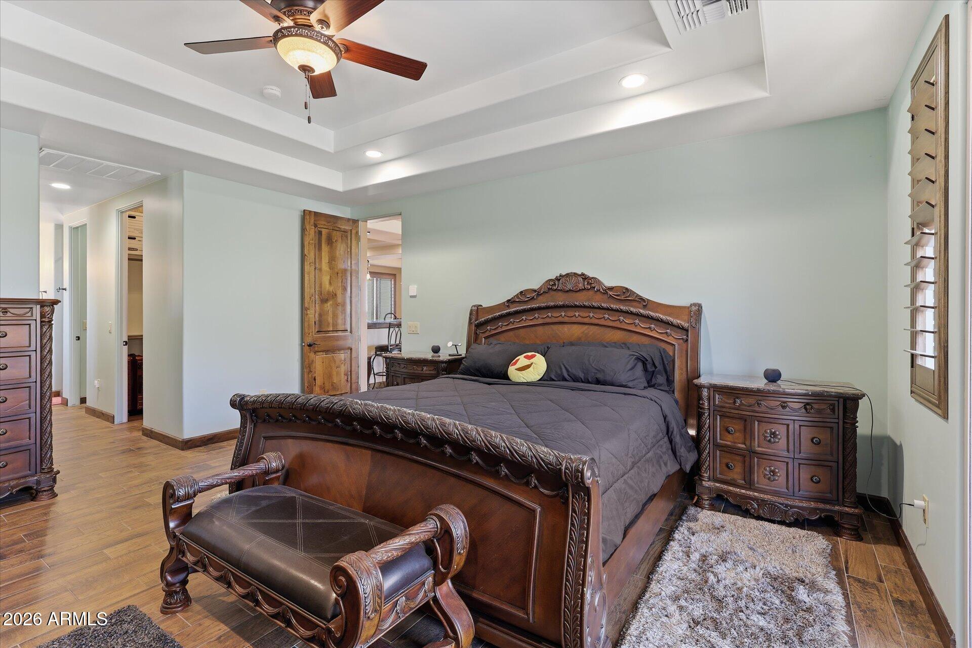 53 North La Barge Road Apache Junction, AZ 85119 - Photo 4 of 40 a bedroom with a bed and wooden floor