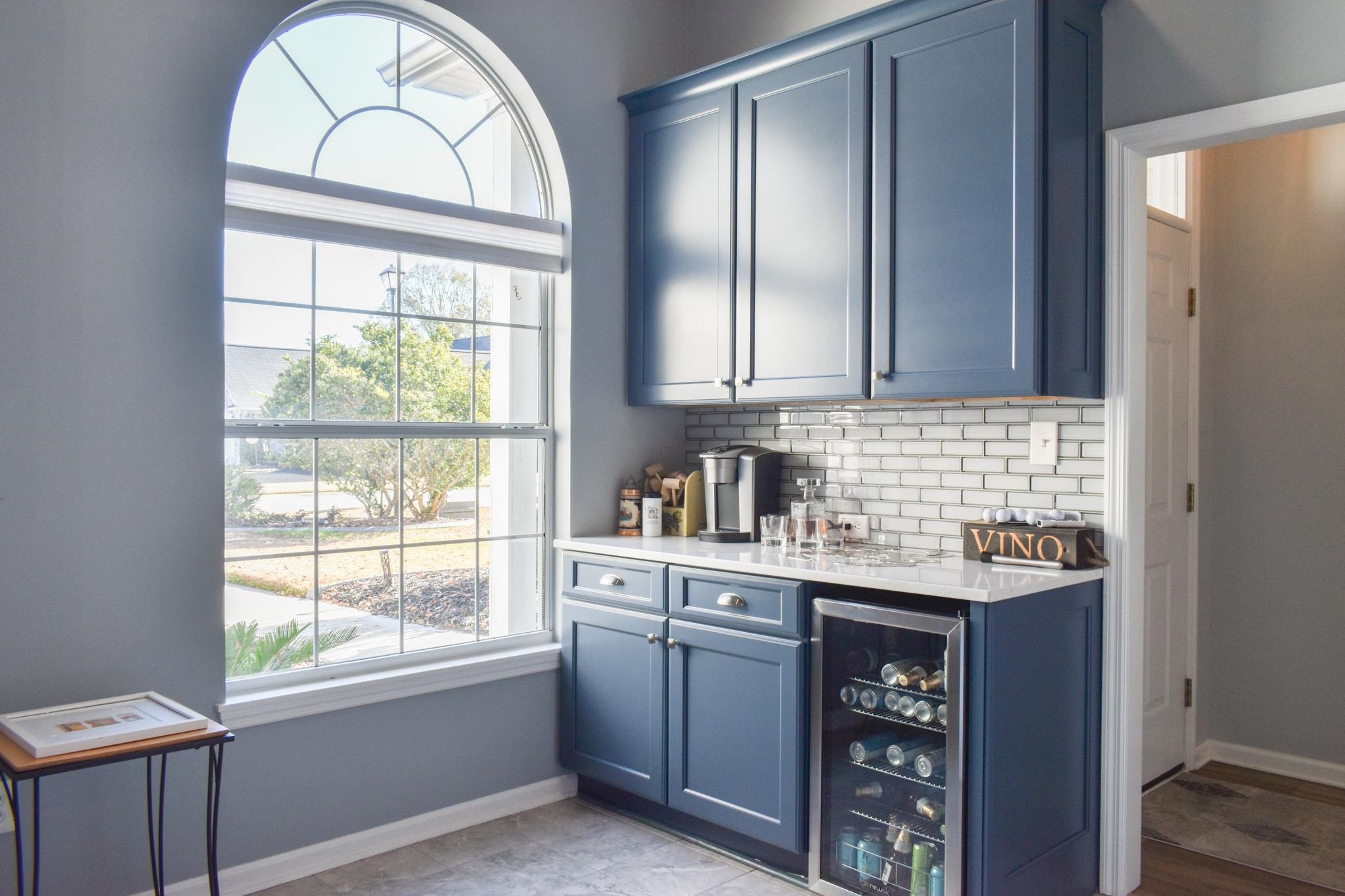 1670 Sedgefield Drive Murrells Inlet, SC 29576 - Photo 14 of 14 Indoor dry bar featuring beverage cooler, blue cabinetry, and healthy amount of natural light