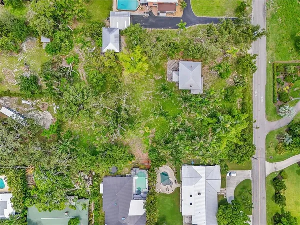 an aerial view of a house with a yard