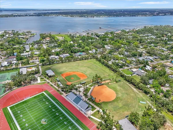an aerial view of a pool yard lake and outdoor seating
