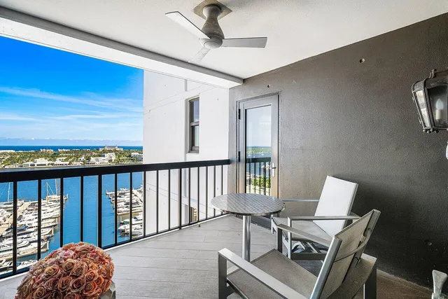 a kitchen with stainless steel appliances wooden floor and staircase