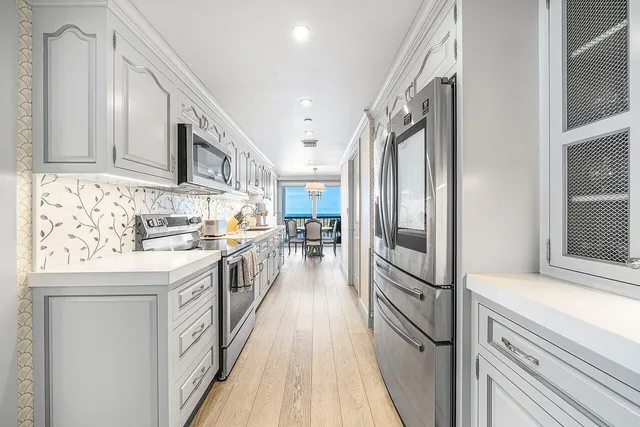 a kitchen with granite countertop white cabinets and white appliances