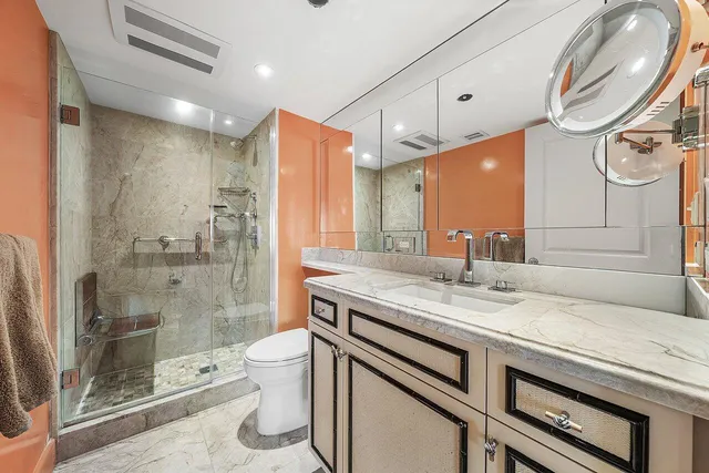 a bathroom with a sink toilet and shower