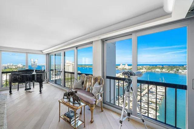 a view of a workspace with furniture and floor to ceiling window