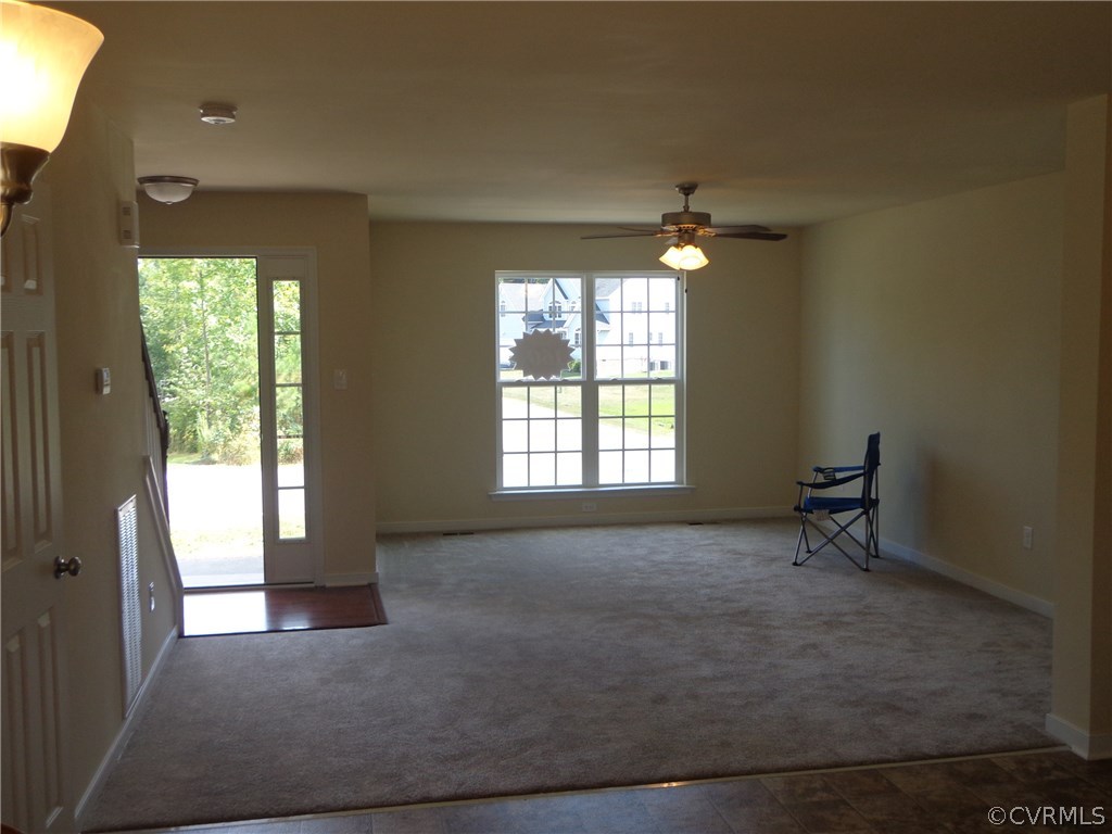 9719 Gdn Rdg Trace Chesterfield, VA 23832 - Photo 3 of 10 an empty room with windows and ceiling fan