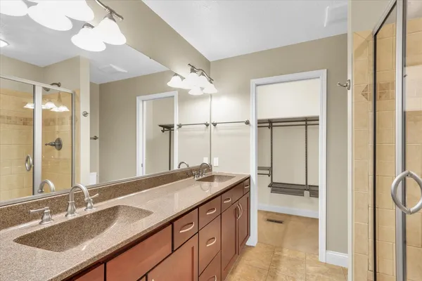 a bathroom with a granite countertop sink mirror and double