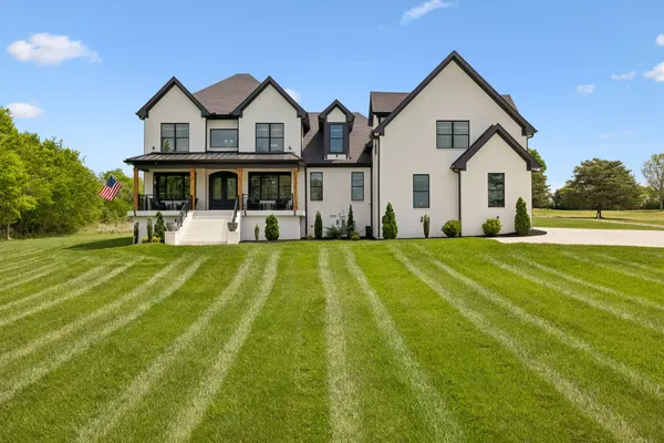 a front view of house with yard and green space