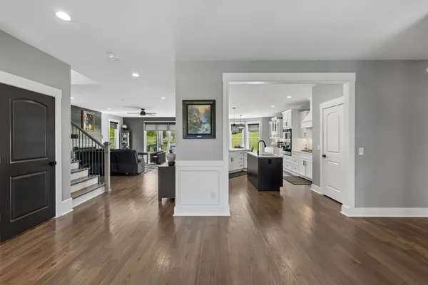a living room with furniture a floor to ceiling window and a fireplace
