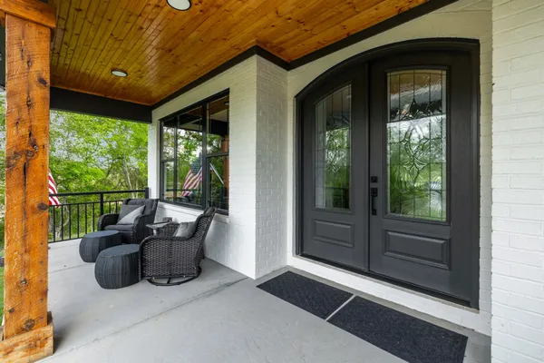 a kitchen with stainless steel appliances granite countertop a table chairs stove and wooden floor