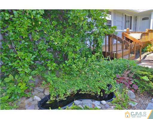 171 Normandy Road Colonia, NJ 07067 - Photo 22 of 23 a view of a garden with a building