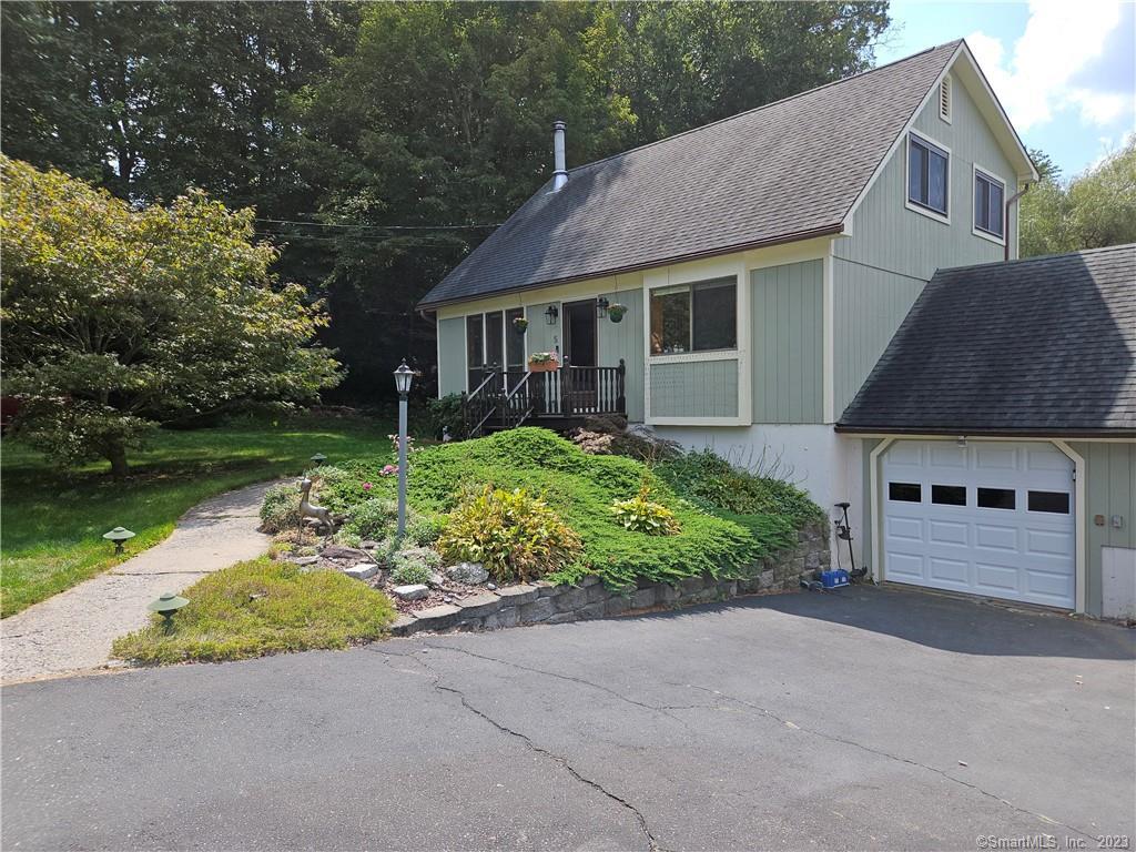 5 Beacon Manor Road Naugatuck, CT 06770 - Photo 1 of 1 a front view of a house with a garden and yard