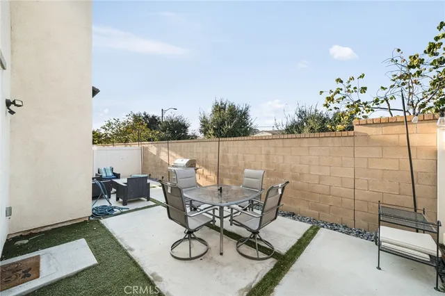 a view of a chairs and table in patio
