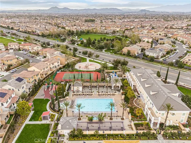 an aerial view of residential houses with outdoor space and swimming pool