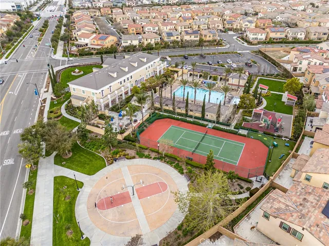 an aerial view of a swimming pool a yard and mountain view in back