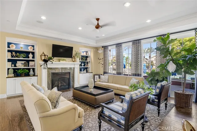 a living room with furniture a fireplace and a flat screen tv