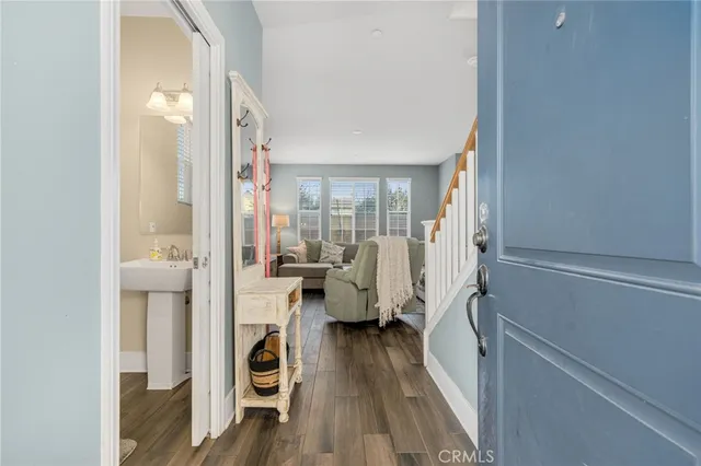 a view of a bedroom with wooden floor and a window