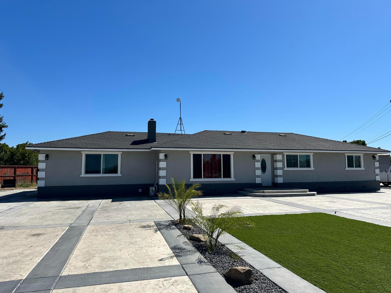 20630 Santa Fe Road Escalon, CA 95320 - Photo 1 of 1 a front view of a house with a yard
