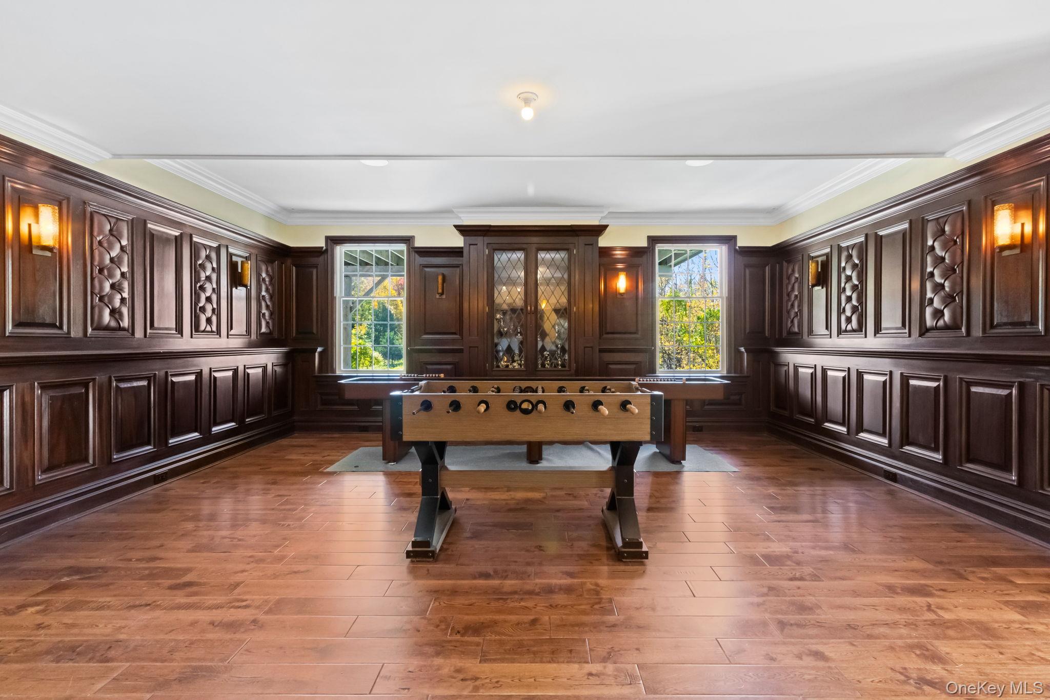 496 Long Ridge Road Bedford, NY 10576 - Photo 39 of 49 Playroom with ornamental molding, plenty of natural light, and dark wood finished floors