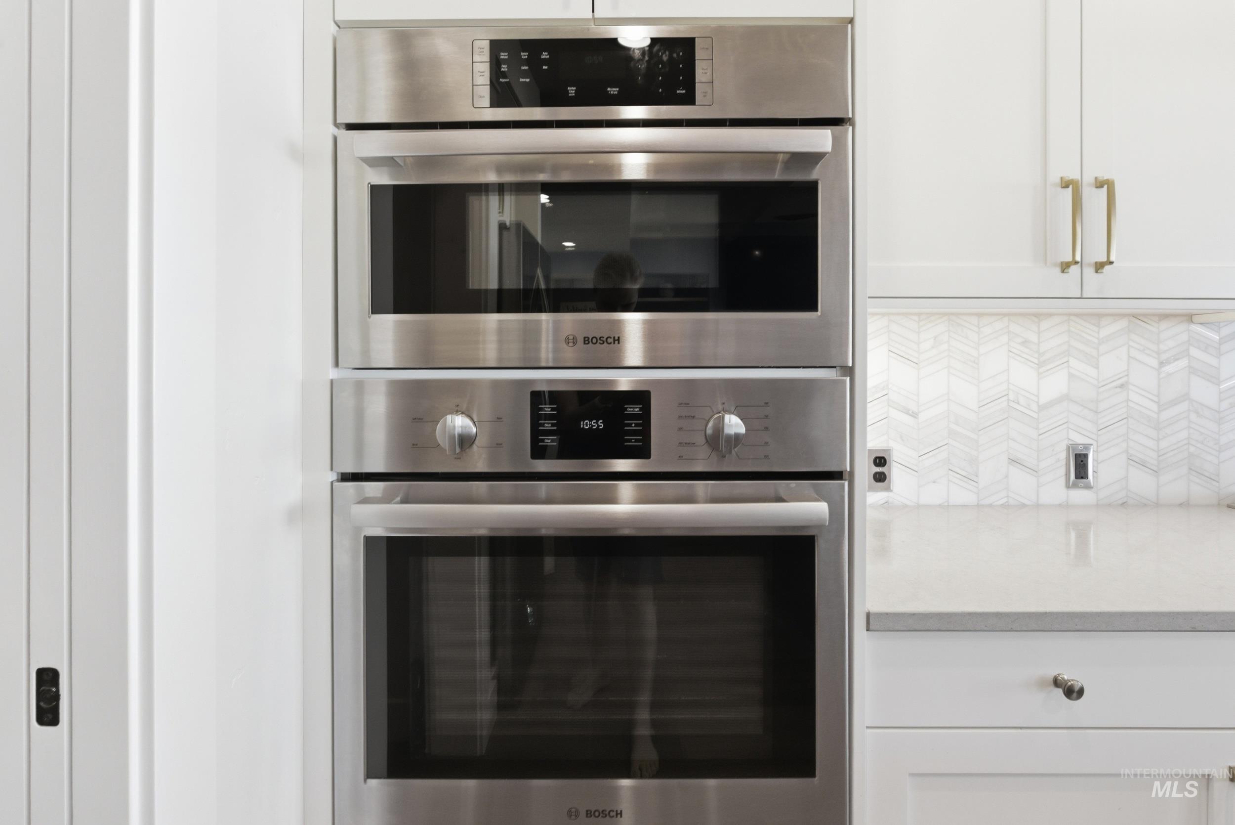 6347 South Utmost Lane Meridian, ID 83642 - Photo 11 of 37 Integrated stainless steel wall oven and microwave, set within white cabinetry