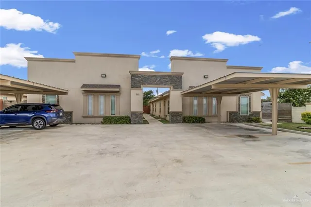 a view of a car park in front of house