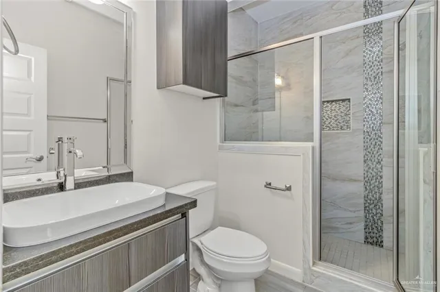 a bathroom with a sink toilet and shower