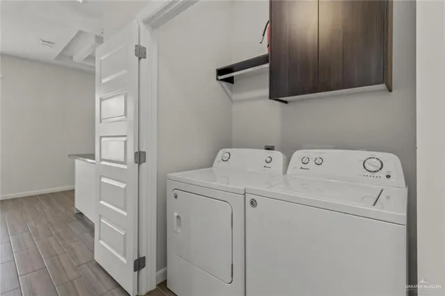 a view of storage and utility room with washer and dryer