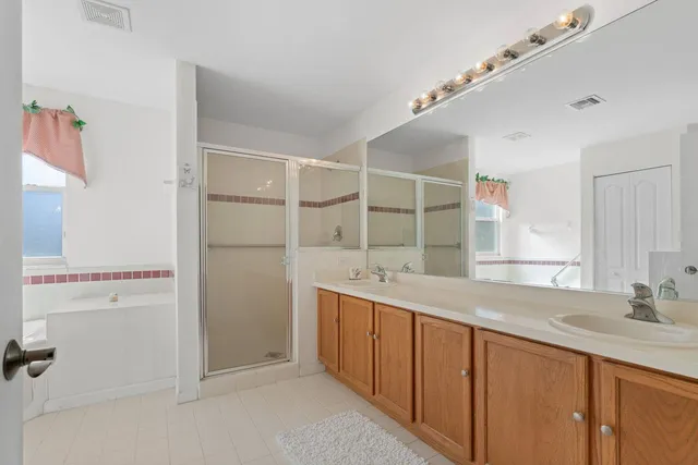 a bathroom with a double vanity sink and mirror