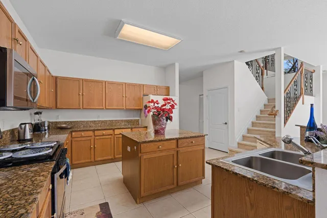 a kitchen with granite countertop a sink and cabinets